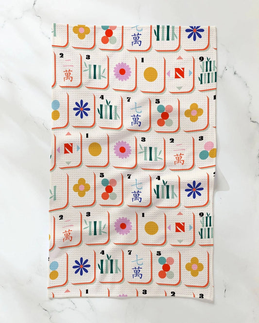 Geometric patterned tea towel with colorful tile design